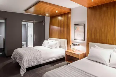 a hotel room with two beds and a bathroom at Le Meridien Columbus, The Joseph in Columbus