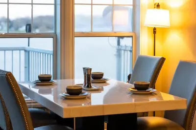 a table with chairs and cups and a laptop on it at RiverFront Landing in Rossford