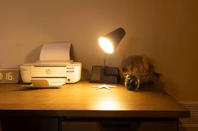 a desk with a printer and a lamp on it at RiverFront Landing in Rossford