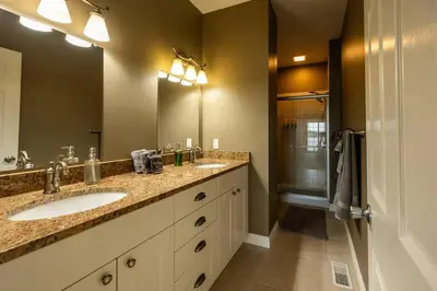 a bathroom with two sinks and a shower at RiverFront Landing in Rossford