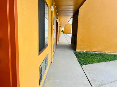 an empty hallway of a building with a yellow wall at Value Stay in Winchester