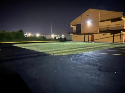 an empty parking lot in front of a building at night at Value Stay in Winchester