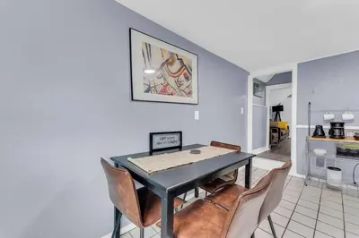 a dining room with a table and chairs at Quaint 2 Bedrooms in Historic Little Italy in Ambler Heights