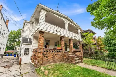 an old brick house with a white door at Quaint 2 Bedrooms in Historic Little Italy in Ambler Heights