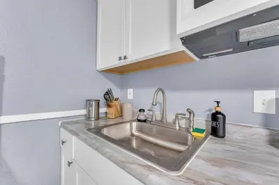 a kitchen counter with a stainless steel sink at Quaint 2 Bedrooms in Historic Little Italy in Ambler Heights