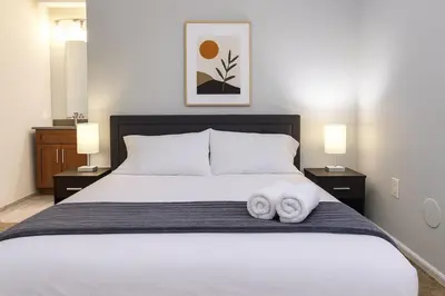 a bedroom with a bed with two towels on it at Modern Luxe Suite Rock Hall, Stadiums, Casino in Cleveland
