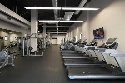 a gym with a row of treadmills and machines at Modern Luxe Suite Rock Hall, Stadiums, Casino in Cleveland