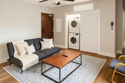 a living room with a couch and a washing machine at Modern Luxe Suite Rock Hall, Stadiums, Casino in Cleveland