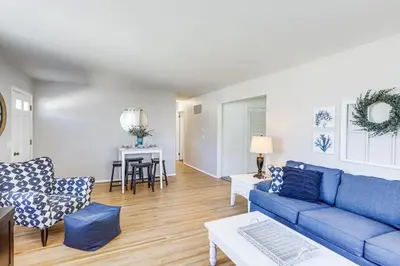 a living room with a blue couch and a table at Waterfront Port Clinton Cottage 5 Mi to Lake Erie in Port Clinton