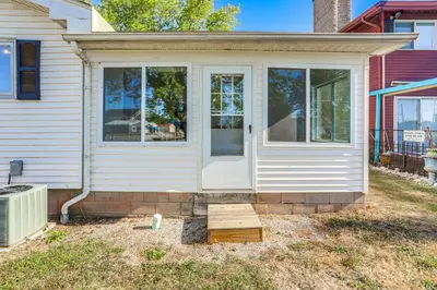 a front door of a house with a porch at Waterfront Port Clinton Cottage 5 Mi to Lake Erie in Port Clinton