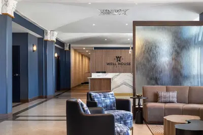 a lobby with two chairs and a couch at The Well House Hamilton, Tapestry Collection By Hilton in Hamilton