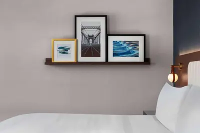a room with three pictures on a wall with a bed at The Well House Hamilton, Tapestry Collection By Hilton in Hamilton