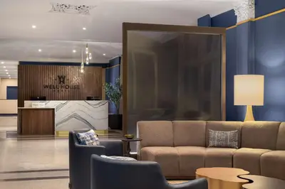 a lobby with a couch and chairs and a counter at The Well House Hamilton, Tapestry Collection By Hilton in Hamilton