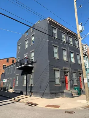 a gray building on the corner of a street at Lux Townhome - Washington Park - Walk to ALL in Cincinnati