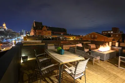 a patio with a table and chairs on a roof at Lux Townhome - Washington Park - Walk to ALL in Cincinnati