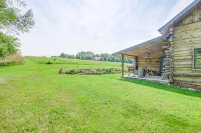 a log cabin with a grass yard next to it at 1800s Romantic Cabin! Fireplace and 3 Jacuzzi Tubs in Paris