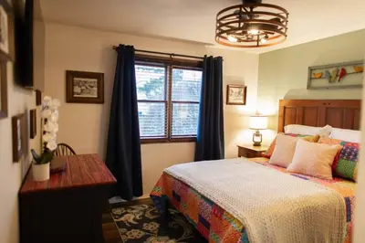 a bedroom with a bed and a window at The General's Quarters in Defiance