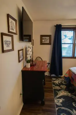 a room with a desk in a room with a window at The General's Quarters in Defiance