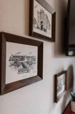 three pictures hanging on a wall in a room at The General's Quarters in Defiance