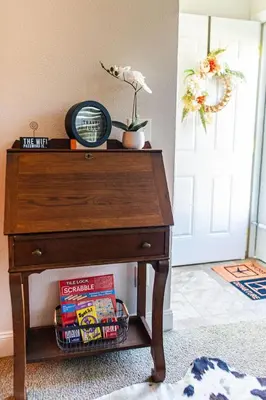 a wooden table with books on it next to a door at The Aviators Lounge in Defiance