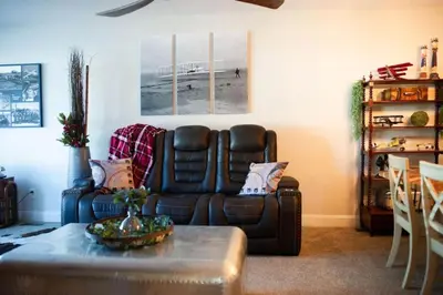 a living room with a leather couch and a table at The Aviators Lounge in Defiance