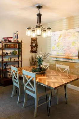 a dining room with a wooden table and chairs at The Aviators Lounge in Defiance