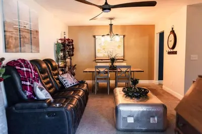 a living room with a leather couch and a table at The Aviators Lounge in Defiance