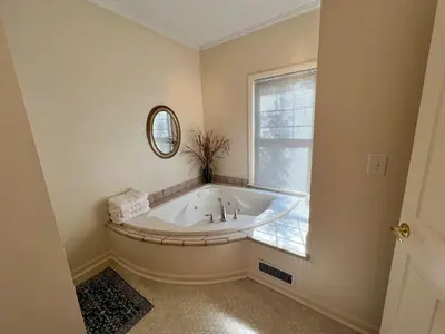 a bath tub in a bathroom with a window at The Mount Vernon Inn in Mount Vernon