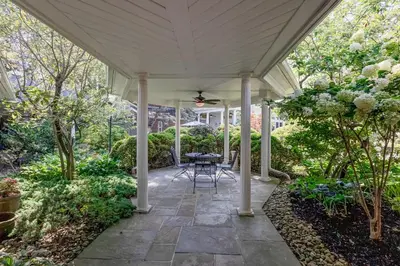 a patio with a table and chairs under a roof at The Mount Vernon Inn in Mount Vernon