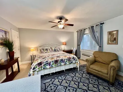 a bedroom with a bed and a ceiling fan at The Mount Vernon Inn in Mount Vernon