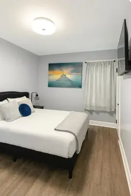 a bedroom with a large bed and a window at Spacious Three Bedroom Parma Home Sleeps six Near Cleveland in Parma