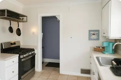 a kitchen with a stove and a sink at Spacious Three Bedroom Parma Home Sleeps six Near Cleveland in Parma