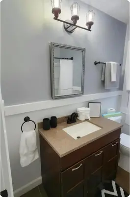 a bathroom with a sink and a mirror at Spacious Three Bedroom Parma Home Sleeps six Near Cleveland in Parma