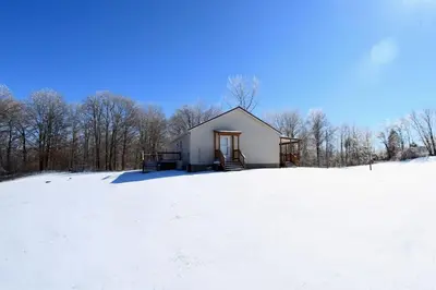 a small house in a field in the snow at The Den at Buckskin- Entire House in Frankfort, OH in Greenfield