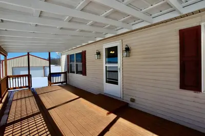 a porch of a house with a wooden deck at The Den at Buckskin- Entire House in Frankfort, OH in Greenfield