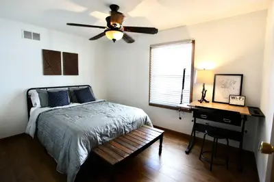 a bedroom with a bed and a ceiling fan at The Den at Buckskin- Entire House in Frankfort, OH in Greenfield