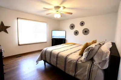 a bedroom with a bed and a ceiling fan at The Den at Buckskin- Entire House in Frankfort, OH in Greenfield