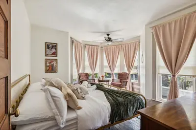 a bedroom with a bed and a large window at Meerkat Manor- 5 Min Drive to CLE Clinic in Cleveland