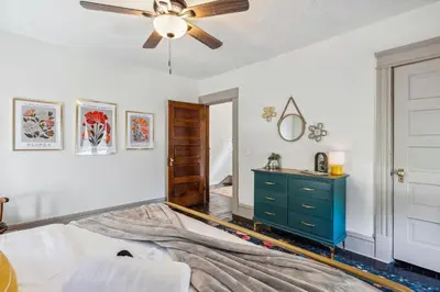 a bedroom with a ceiling fan and a blue dresser at Meerkat Manor- 5 Min Drive to CLE Clinic in Cleveland