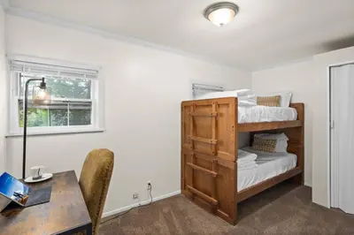 a room with a desk and a bunk bed at Cozy Bungalow 10 Min to DTWN CLE in Euclid
