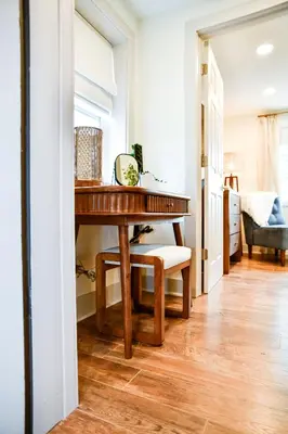 a wooden table in a room with a bedroom at The Bidwell Bungalow in Amanda