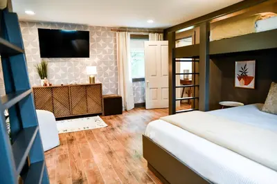 a bedroom with a bed and a tv on a wall at The Bidwell Bungalow in Amanda