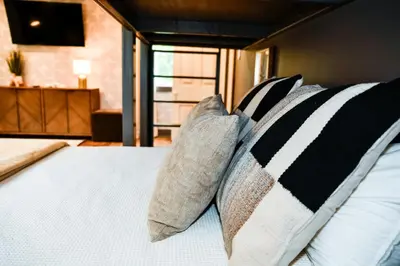a bedroom with a bed with two pillows at The Bidwell Bungalow in Amanda