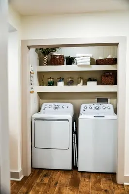 two washing machines in a kitchen with shelves at The Bidwell Bungalow in Amanda