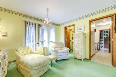 a living room with a chair and a dresser at Retro Ohio Home on 1-Acre Property in Xenia