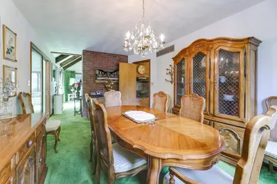 a dining room with a wooden table and chairs at Retro Ohio Home on 1-Acre Property in Xenia