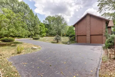 a driveway leading to a building with a garage at Retro Ohio Home on 1-Acre Property in Xenia