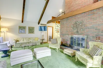 a living room with a brick wall at Retro Ohio Home on 1-Acre Property in Xenia