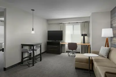 a living room with a couch and a table and a television at Residence Inn by Marriott Dayton Miamisburg in Miamisburg