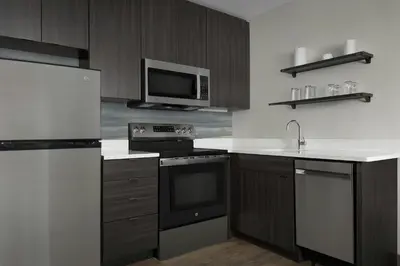 a kitchen with a stove and a microwave at Residence Inn by Marriott Dayton Miamisburg in Miamisburg